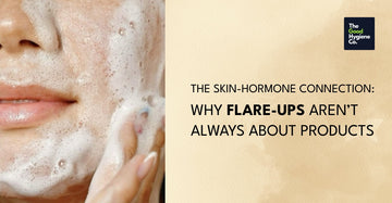 Woman touching face with concern, representing hormonal skin flare-ups like acne, redness, and sensitivity.