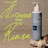 Blue bottle of 'The Conditioning Body Rinse' by The Good Company on a white background
